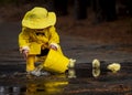 Child Enjoying The Rain In His Galoshes Royalty Free Stock Photo