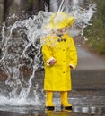 Child Enjoying The Rain In His Galoshes Royalty Free Stock Photo