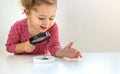 A child examines a plant under a magnifying glass. Selective focus. Royalty Free Stock Photo
