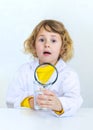 A child examines water with a magnifying glass. Selective focus. Royalty Free Stock Photo