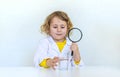 A child examines water with a magnifying glass. Selective focus. Royalty Free Stock Photo