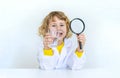 A child examines water with a magnifying glass. Selective focus. Royalty Free Stock Photo