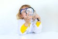 A child examines water with a magnifying glass. Selective focus. Royalty Free Stock Photo
