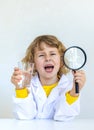 A child examines water with a magnifying glass. Selective focus. Royalty Free Stock Photo