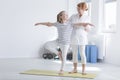 Child exercising with female physiotherapist