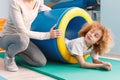 Child exercising with play tunnel Royalty Free Stock Photo