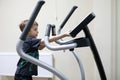 Child exercising at stride treadmill Royalty Free Stock Photo