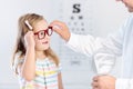 Child at eye sight test. Kid at optitian. Eyewear for kids.