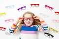 Child at eye sight test. Kid at optitian. Eyewear for kids. Royalty Free Stock Photo