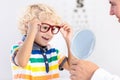 Child at eye sight test. Kid at optitian. Eyewear for kids.