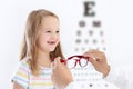 Child at eye sight test. Kid at optitian. Eyewear for kids.