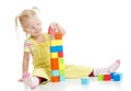 Child in eyeglases playing building blocks