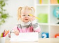 Child in eyeglasses drawing picture at home Royalty Free Stock Photo