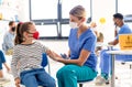 Child with face mask getting vaccinated, coronavirus, covid-19 and vaccination concept. Royalty Free Stock Photo