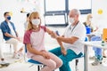 Child with face mask getting vaccinated, coronavirus, covid-19 and vaccination concept. Royalty Free Stock Photo