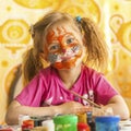 Child with a face painted with colorful paints. Fun. Royalty Free Stock Photo