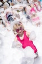 Child with face painting and foam party