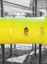 Child face in tunnel lonely in playground park missing friends and peers during pandemic social distancing