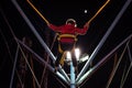 Child at a fair jumping on a Bungee Trampoline during the night Royalty Free Stock Photo