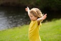 Child faith, praise and happiness and freedom. Kid resting in summer park. Kid put face to the sun, closed her eyes and Royalty Free Stock Photo