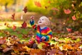 Child in fall park. Kid with autumn leaves. Royalty Free Stock Photo
