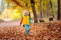 Child in fall park. Kid with autumn leaves Royalty Free Stock Photo