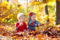 Child in fall park. Kid with autumn leaves Royalty Free Stock Photo