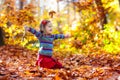 Child in fall park. Kid with autumn leaves Royalty Free Stock Photo