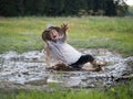 Child falls in a puddle. Field. Royalty Free Stock Photo