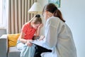 Child family psychology, female therapist talking to girl child Royalty Free Stock Photo