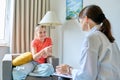 Child family psychology, female therapist talking to girl child Royalty Free Stock Photo