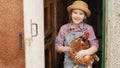 a little girl holds a red hen in a chicken coop. laying hen.