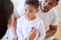 Child, father and doctor with stethoscope in healthcare service, listening to heart or lung test or flu exam. Family Royalty Free Stock Photo