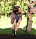 Child, father and help with gardening in nature using tools for agriculture conservation and ecology education. Soil