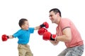 Child and father play with boxing gloves