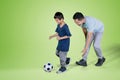 Child and father playing football in the studio Royalty Free Stock Photo