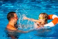 Child and father playing in swimming pool Royalty Free Stock Photo