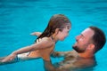 Child and father playing in swimming pool Royalty Free Stock Photo