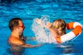 Child and father playing in swimming pool Royalty Free Stock Photo