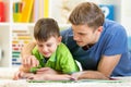 Child and father read a book on floor at home Royalty Free Stock Photo