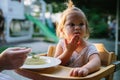 Child feading with soup at the restaurant garden Royalty Free Stock Photo