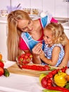 Child feed mother at kitchen