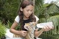 Child feeding baby tiger