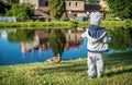 Child feeding birds near pond Royalty Free Stock Photo