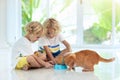 Child feeding home cat. Kids and pets Royalty Free Stock Photo