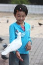 Child feeding pigeon Royalty Free Stock Photo