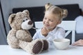 Child feeding teddy bear Royalty Free Stock Photo