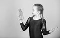 Child feel thirst after sport training. Kid cute girl gymnast sports leotard hold bottle for drink. Water balance and Royalty Free Stock Photo