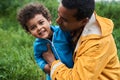 Child feeling joyful while embracing with his multiracial father
