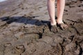 Child feet in dark volcanic sand on Tenerife beach Royalty Free Stock Photo